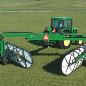Tractor with wheel rakes attached