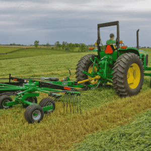 Tractor with rotary rakes attached