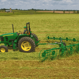 John Deere tractor with wheel rakes attached