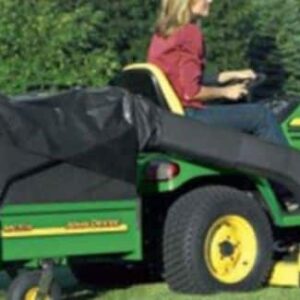 Woman riding a mower with a cart attached