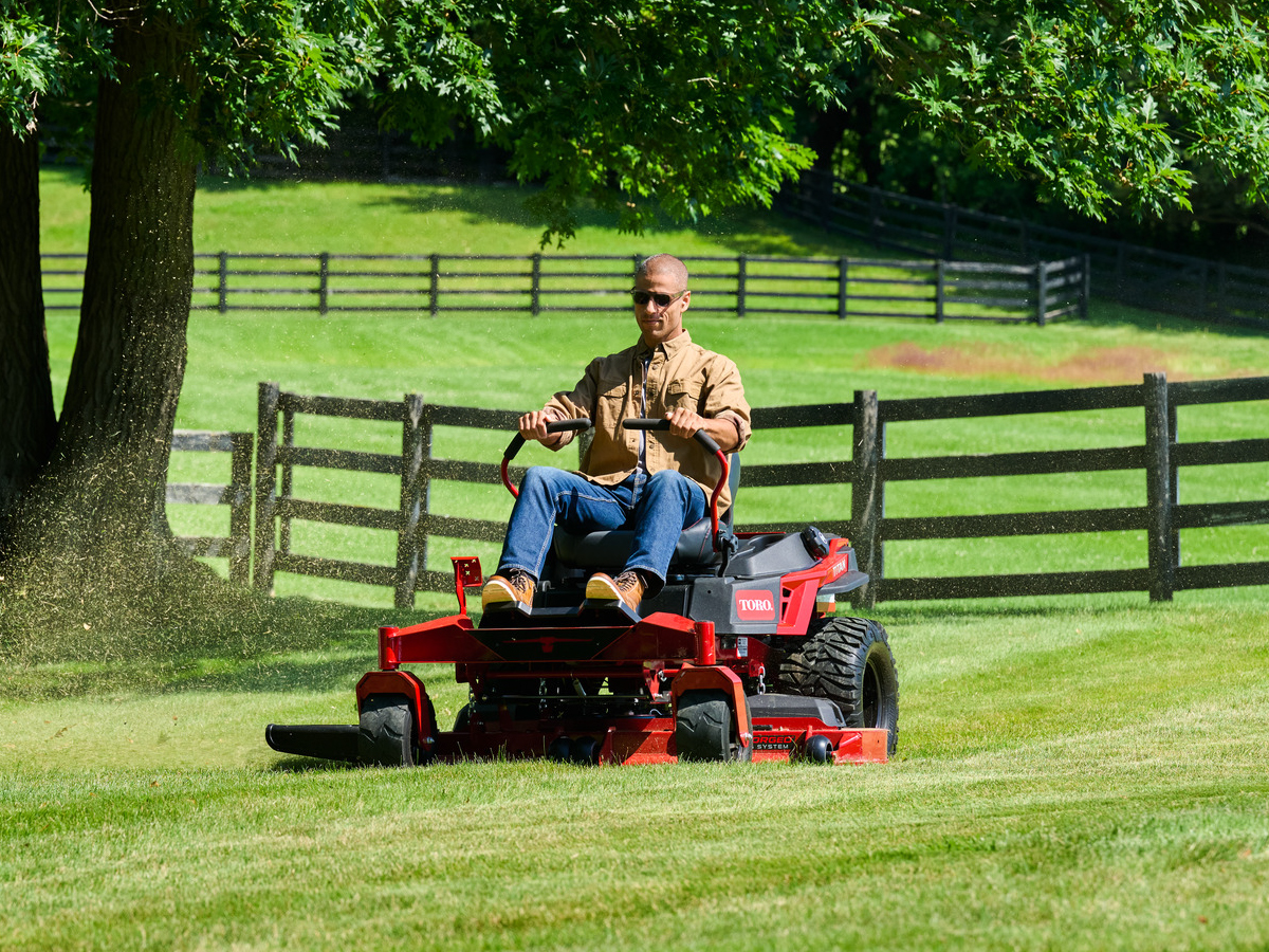 Person mowing using a toro titan mower