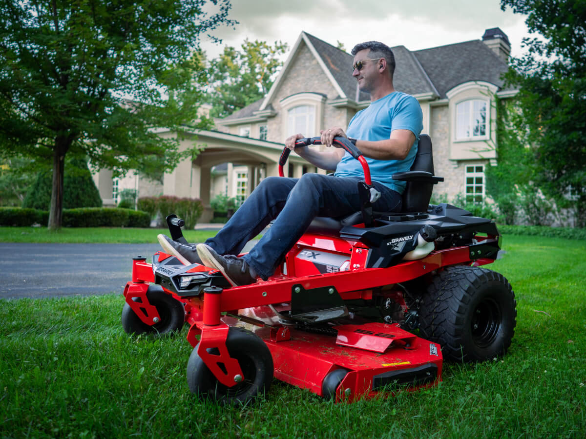 person on gravely mower