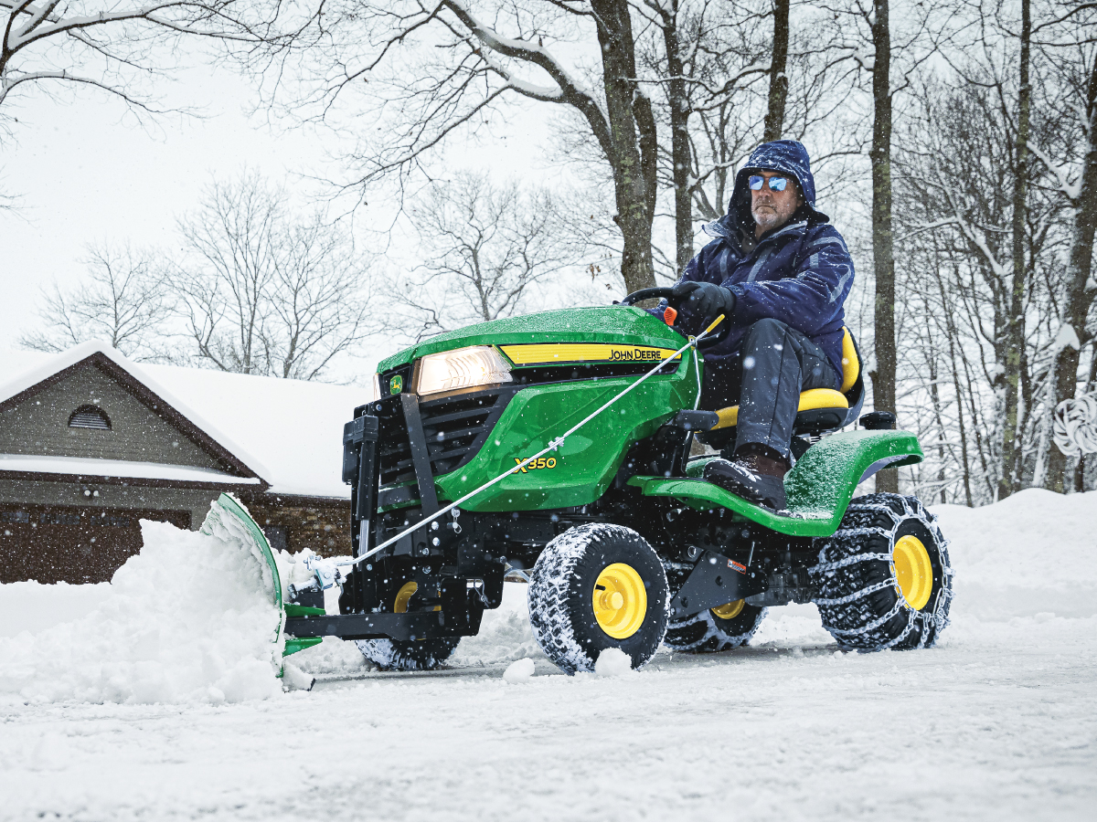 person riding on a John Deere x350 riding mower
