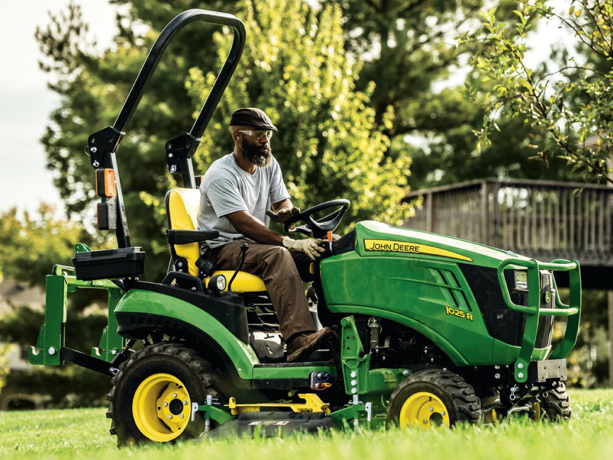 Person using 1025R compact tractor